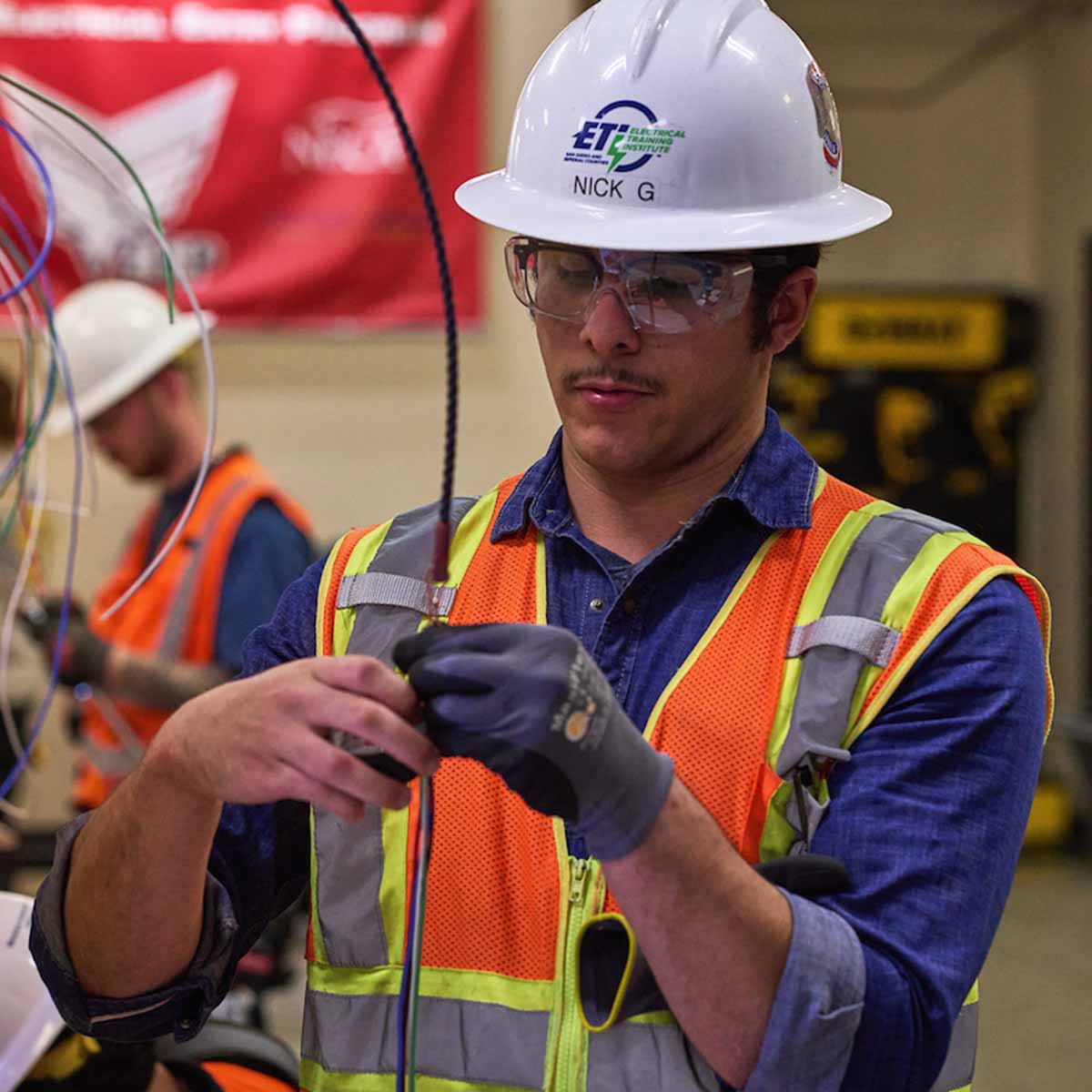 Electrician trainee in school working with wires.