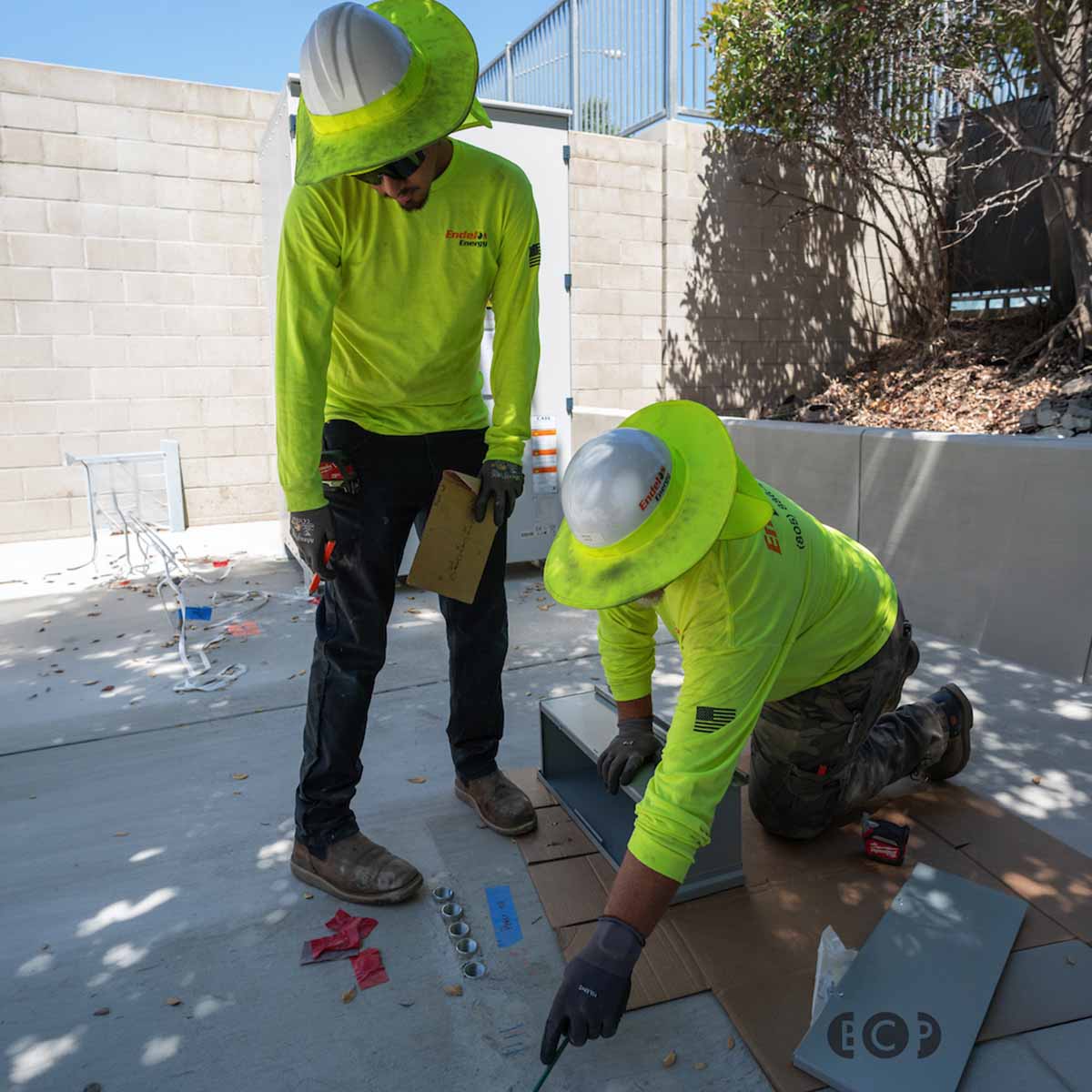 An Electrician and Trainee working on the jobsite.