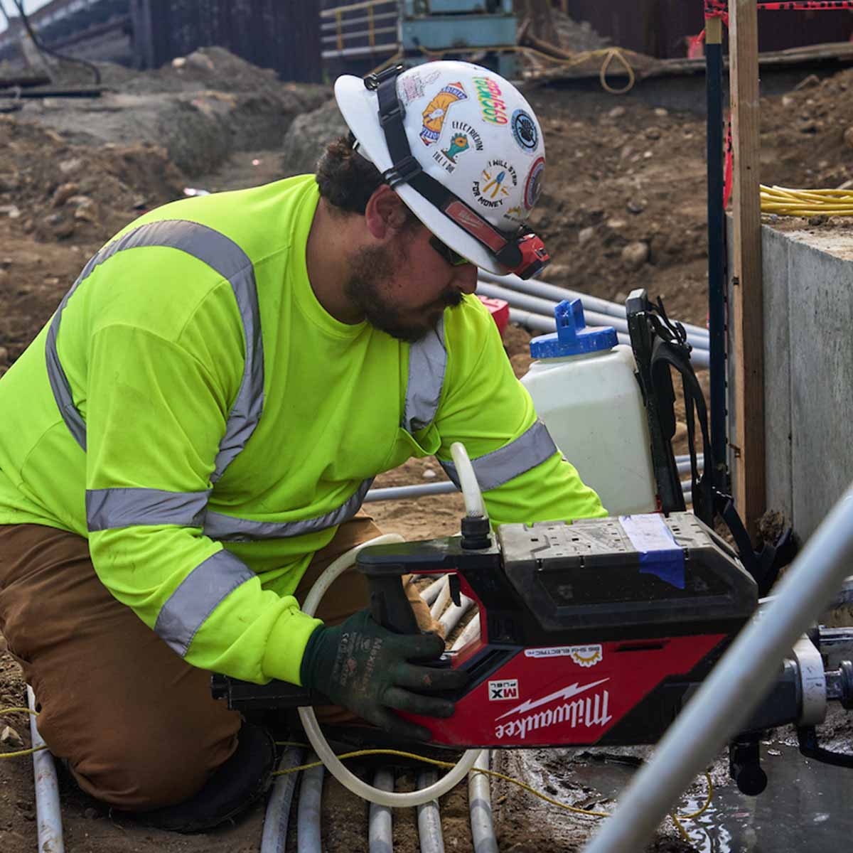 Electrician using a large drill.