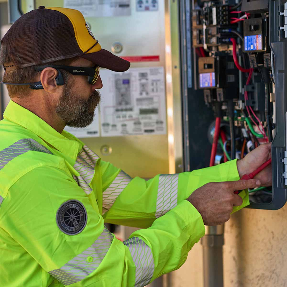 Electrician testing a power box